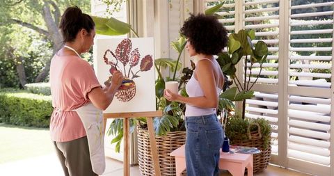 Art class scene with instructor teaching painting techniques