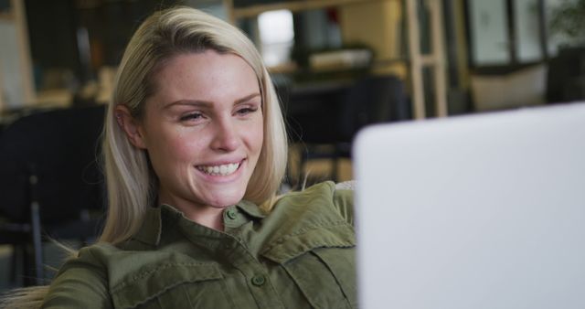 Young Woman Smiling While Working on Laptop in Modern Office - Download Free Stock Images Pikwizard.com