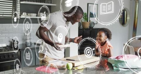 Father guiding daughter on kitchen island using augmented reality learning icons