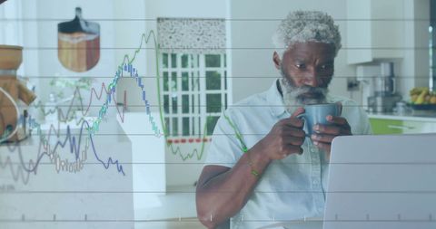 Senior Man Analyzing Financial Data on Laptop with Coffee