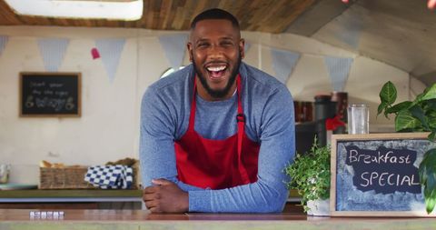 Smiling African American Food Truck Owner with Breakfast Menu