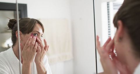 Woman Intently Examining Skin in Mirror for Morning Beauty Routine - Download Free Stock Images Pikwizard.com