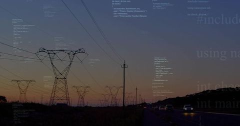 High-voltage transmission towers silhouetting against twilight sky along rural highway