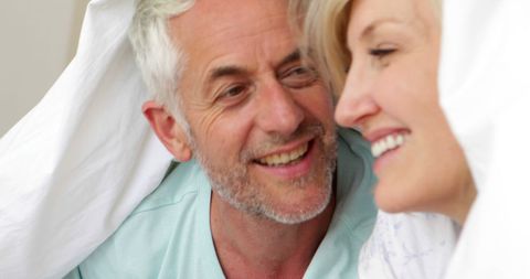Happy Mature Couple Relaxing in Bed Under Quilt - Download Free Stock Images Pikwizard.com
