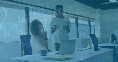 Business people discussing in office with financial data overlay