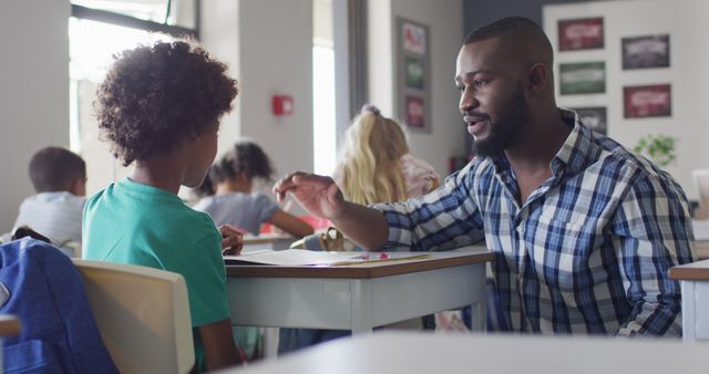 Image of happy african american male teacher clapping hands with african american boy - Download Free Stock Photos Pikwizard.com