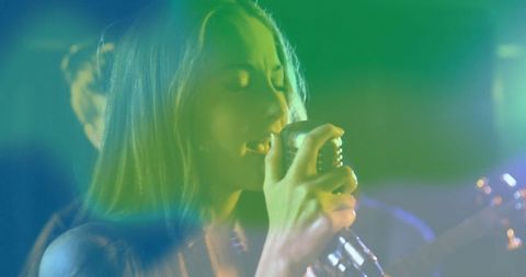 Passionate Vocalist Singing with Vibrant Colored Lights on Stage