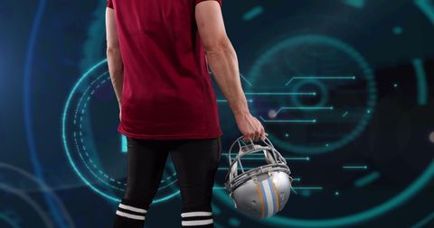 Football player holding helmet in digital sci-fi backdrop