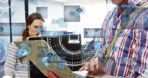 Futuristic office team typing on laptop with holographic hud and data workflow overlay