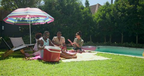 Group of Friends Enjoying Poolside Gathering on Sunny Day