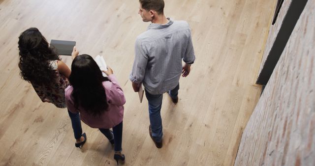 Group of Young Adults Walking and Talking in Bright Office Hallway - Download Free Stock Images Pikwizard.com