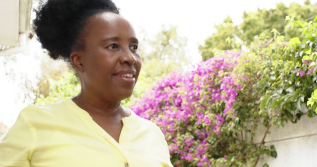 Smiling African American Woman in Yellow Shirt Outdoors in Garden - Download Free Stock Images Pikwizard.com