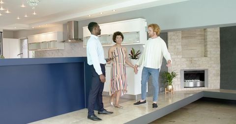 Couple Touring Modern Home with Real Estate Agent