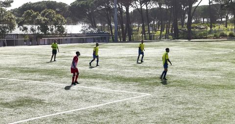 Youth Soccer Team Focusing on Strategy During Match
