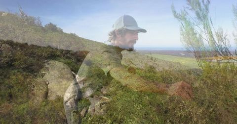 Solitary hiker overlooks coastal landscape with ocean view