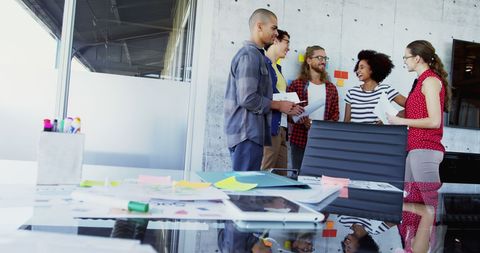 Multiracial team collaborating in modern office space