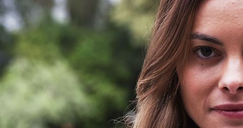 Serene Portrait of Woman with Blurred Garden Background