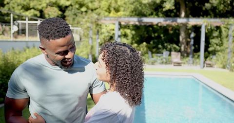 Happy Couple Enjoys Relaxing Moment by Backyard Pool