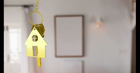 Golden house keychain symbolizing home ownership