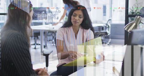 Diverse female coworkers analyzing stock market reports