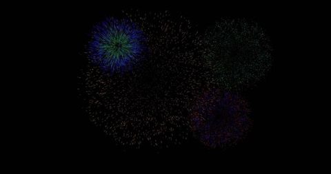 Bursting multicolor fireworks sending radial spark trails across dark night sky