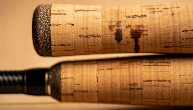 Closeup of cork fishing rod handles showing texture, varnish marks and foam butt caps