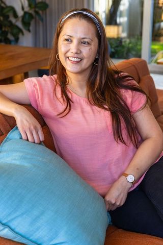 Mature woman relaxing on sofa in stylish living room interior