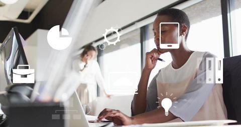 Black professional woman working on laptop in modern office with ar productivity icons