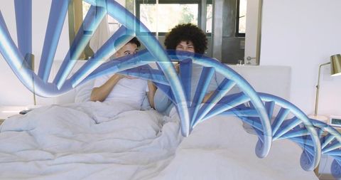 Male couple in bed using phones with blue dna strand overlay symbolizing health and connection
