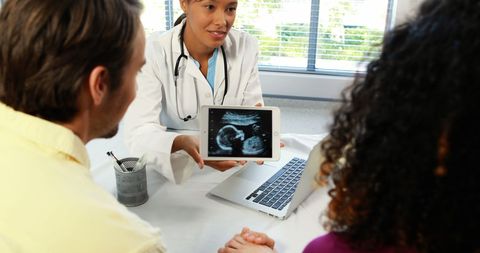 Doctor Presenting Ultrasound Results to Expectant Couple - Download Free Stock Images Pikwizard.com