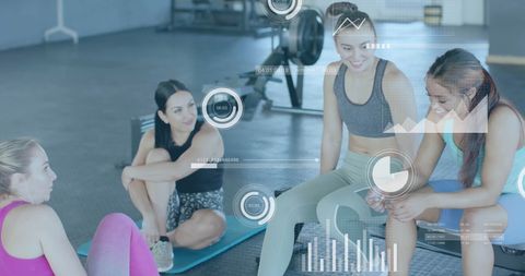 Diverse Women Discussing Fitness Data at Gym