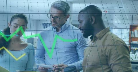 Diverse Team Analyzing Live Stock Market Data in Office