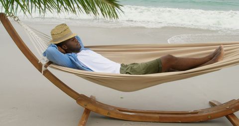 African American Man Relaxing in Hammock on Tranquil Beach - Download Free Stock Images Pikwizard.com