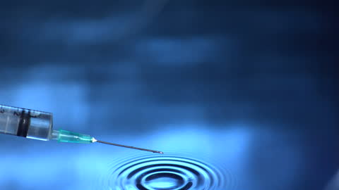 Syringe Tip Creating Ripple in Water in Slow Motion