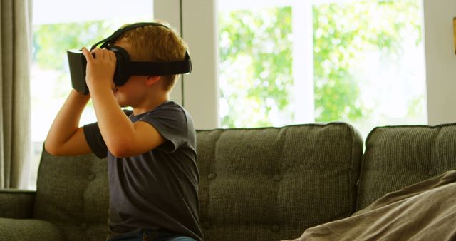 Young Boy Playing With Virtual Reality Headset in Living Room - Download Free Stock Images Pikwizard.com