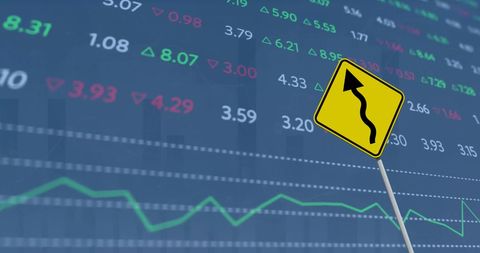 Financial data with curvy road sign symbolizing market trends