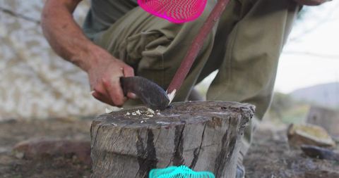 Craftsman Shaving Wood Bark in Rustic Outdoor Setting