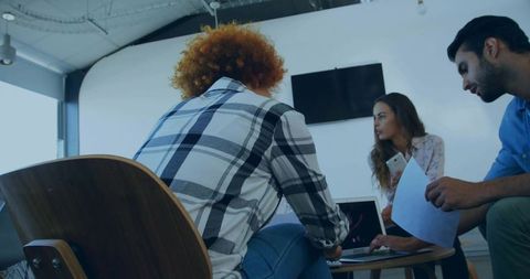 Collaborating Team in Modern Office Discussing Project Details