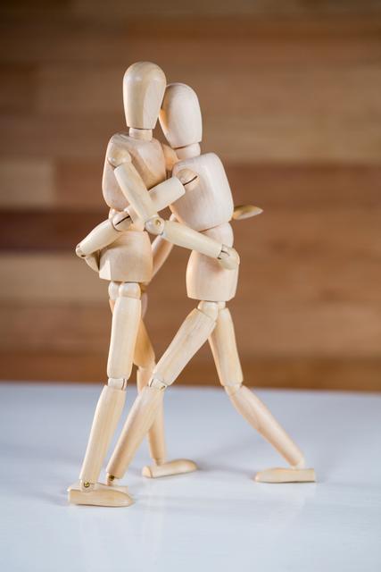 Conceptual image of figurine couple embracing each other
