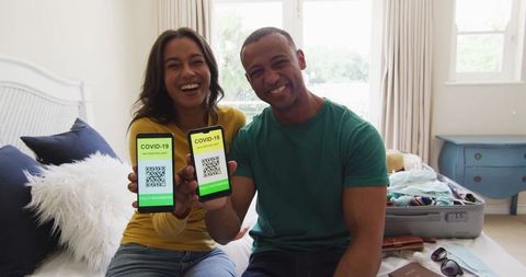 Couple Showing COVID-19 Passports on Smartphones Before Travel - Download Free Stock Images Pikwizard.com