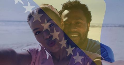 Couple taking beach selfie with bosnia and herzegovina flag overlay, sunny summer moment