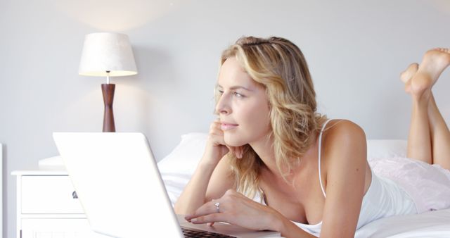 Woman Relaxing on Bed with Laptop - Download Free Stock Images Pikwizard.com