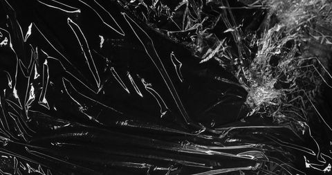 Abstract black plastic wrinkles and creases background