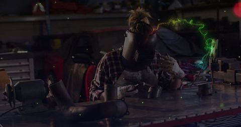 Female Welder Working Meticulously in Garage Workshop