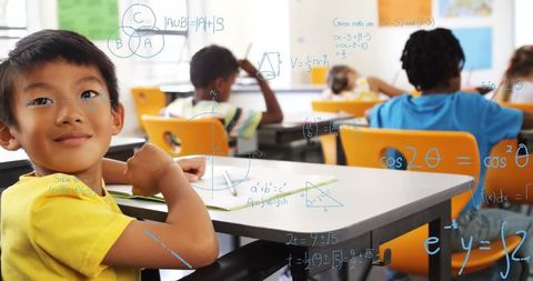 Asian Boy in Classroom with Mathematical Concepts Overlay