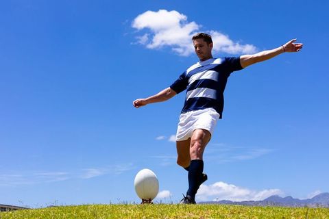 Rugby Player Kicking Rugby Ball on Sunny Day Outdoor Shot - Download Free Stock Images Pikwizard.com