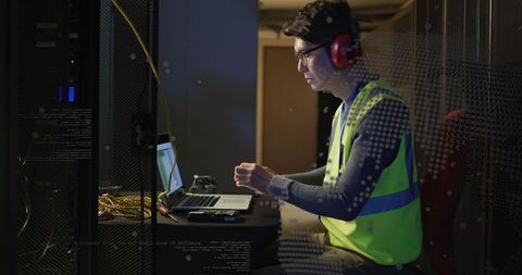 Technician Managing Servers Wearing Neon Vest with Laptop - Download Free Stock Images Pikwizard.com