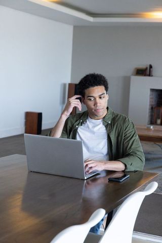 African American Man Working on Laptop in Modern Living Room