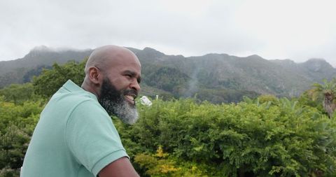Smiling Man Enjoying Scenic Mountain View Outdoors