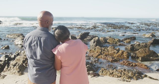 Senior couple embracing standing on rocky beach - Download Free Stock Images Pikwizard.com